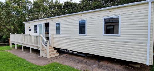 a white trailer with a porch and a staircase at A5 Avocet Rise in Paignton