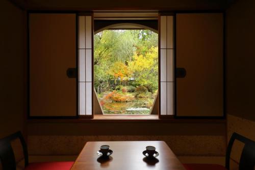 a table in front of a window looking at a garden at Tachibanaya in Tsuruoka