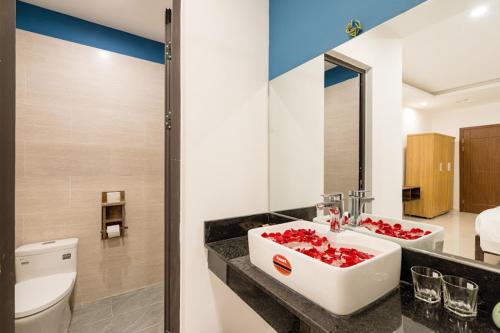 a bathroom with a white sink and a toilet at 5 Coconut Villa in Hoi An