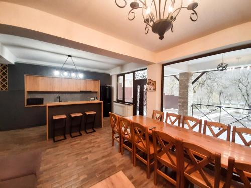 a dining room and kitchen with a wooden table and chairs at Yengibar's Family house in Dilijan