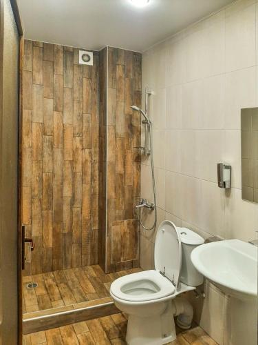 a bathroom with a toilet and a shower and a sink at Yengibar's Family house in Dilijan
