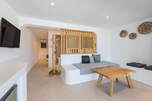 a living room with a couch and a table at Sunset Hill Suites in Mýkonos City