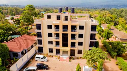 an overhead view of a building with a car parked in front at Snow View Rau Apartments in Moshi