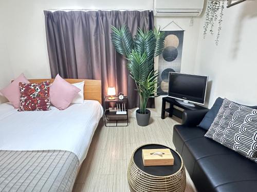 a living room with a couch and a tv at 清水三年坂 Home in Kyoto in Kyoto
