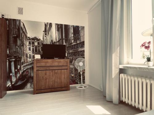 a living room with a tv on a dresser at EASY RENT- Lublin Chopina CityCentre Free Parking 24h Check-in in Lublin