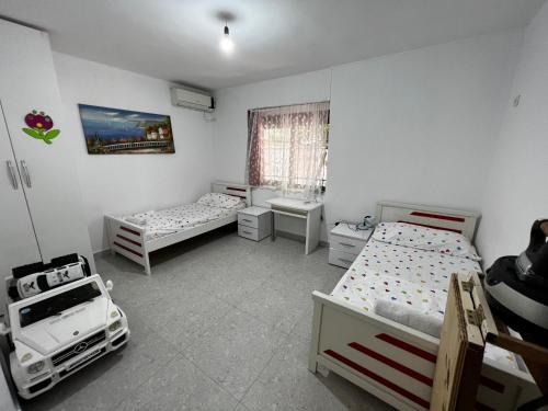 sypialnia z 2 łóżkami, umywalką i oknem w obiekcie BOULEVARD Apartment w Tiranie
