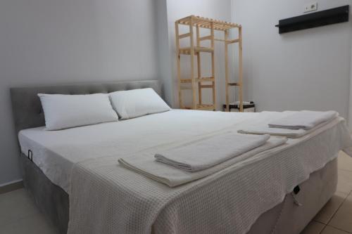 a bed with white sheets and towels on it at power suit in Fethiye