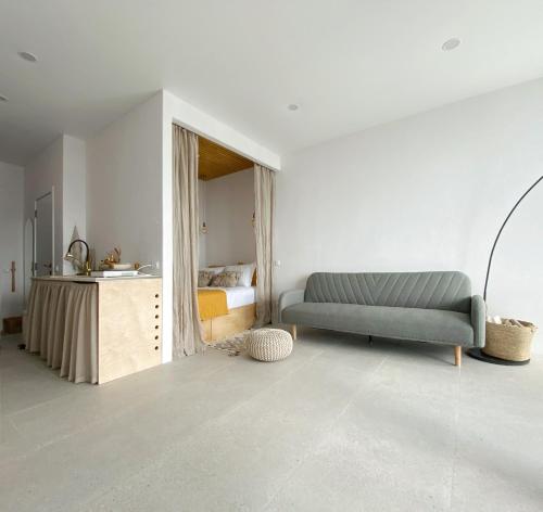 a living room with a couch and a bed at Bohoroom in Chakvi