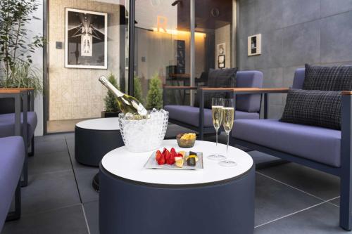 a table with a plate of food and a glass of champagne at Kamo Residences by Reflections in Kyoto