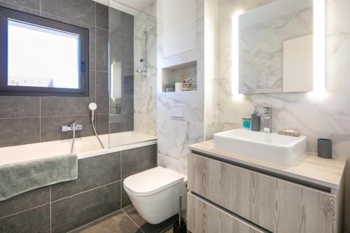 ein Badezimmer mit einem weißen Waschbecken und einem WC in der Unterkunft Le Septentrion chambre d'hôtes 2-4 personnes in Revel