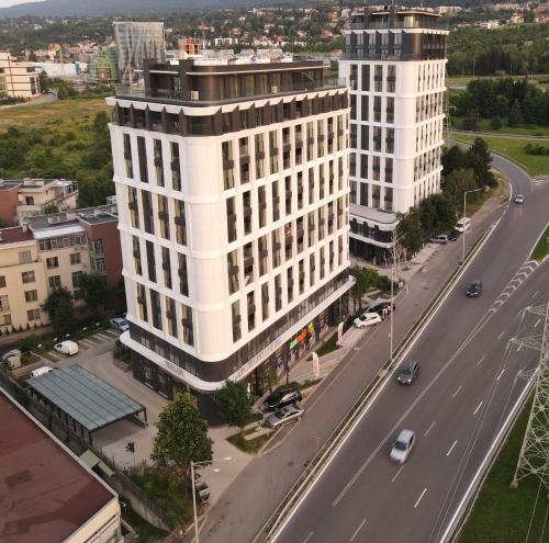 an aerial view of a large white building next to a road at Green Eyes Apartments in Sofia