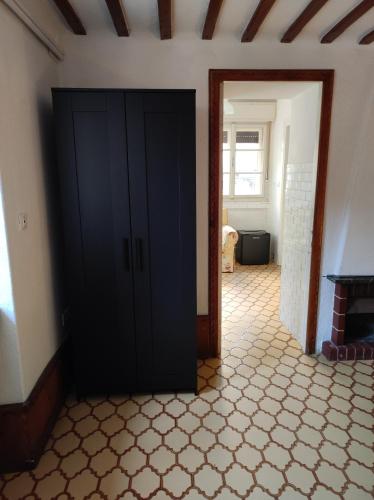 een zwarte kast in een kamer met een tegelvloer bij Affittacamere Esteban in Villa Opicina