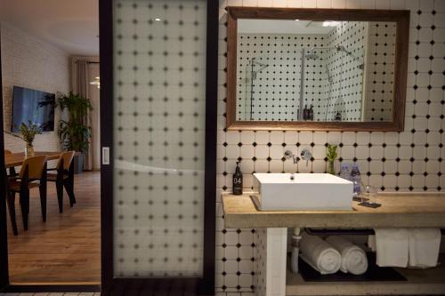 a bathroom with a sink and a mirror at Yi Stack Hotel Beijing in Beijing