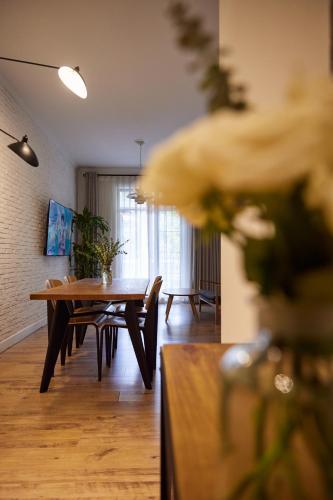 a living room with a wooden table and a dining room at Yi Stack Hotel Beijing in Beijing