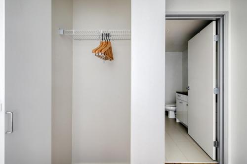 a bathroom with white walls and a mirror and a toilet at South Lake Union studio w gym storage nr parks SEA-558 in Seattle