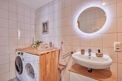 a bathroom with a washing machine and a sink at NEW-Mona - idyllisches Örtchen in Buchen