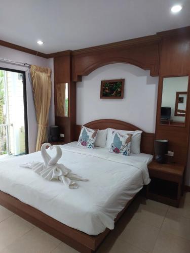 a bedroom with a bed with a flower on it at AINNY Residence in Patong Beach