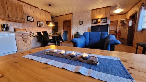 a living room with a table with candles on it at Solbjørnlia Apartments in Trysil