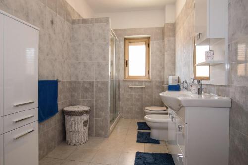 a bathroom with a sink toilet and a shower at Zion Mare in Soverato Superiore