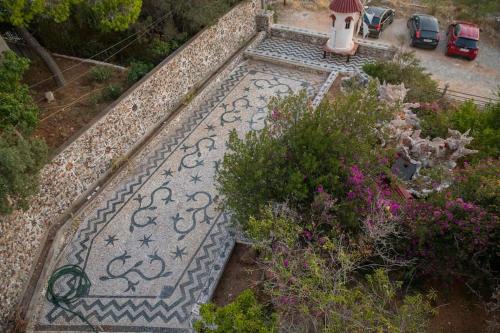 an overhead view of a garden with a tile pathway at Saronicos Gulf View in Anavissos in Anavissos