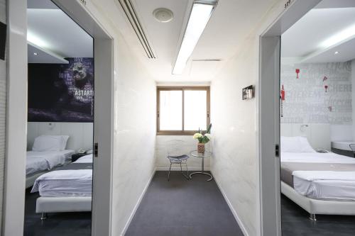 a room with two beds and a window at Aleph Boutique Hotel in Jbeil