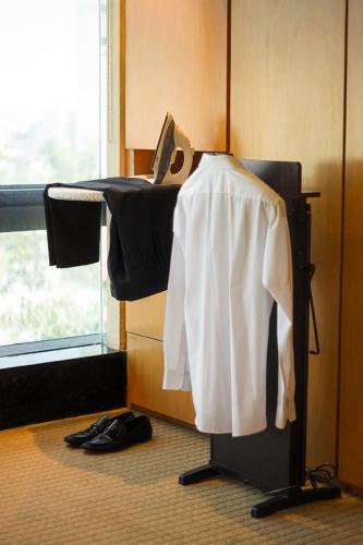 a room with a desk with a white shirt on it at Suites Contempo in Mexico City