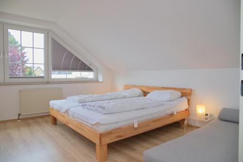 een slaapkamer met 2 bedden en een raam bij Möwenstraße Haus 8 inkl WLAN in Grömitz