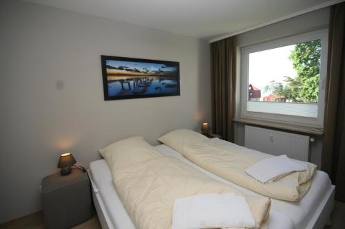 Postel nebo postele na pokoji v ubytování Strandschloss App 49
