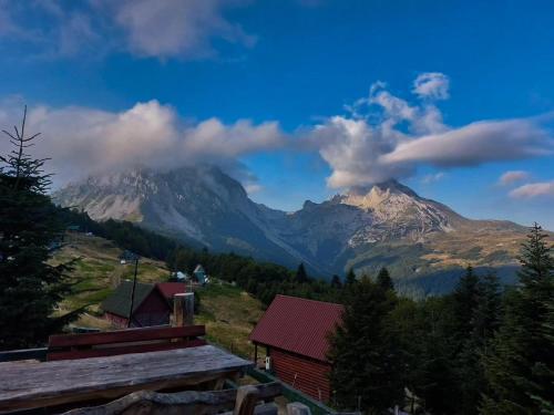 a view of a mountain in the distance with a house at Komovi - Montenegrina Mountain house in Kolašin