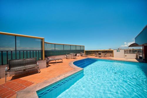 a swimming pool on top of a building at Quality Suites Vila Velha in Vila Velha