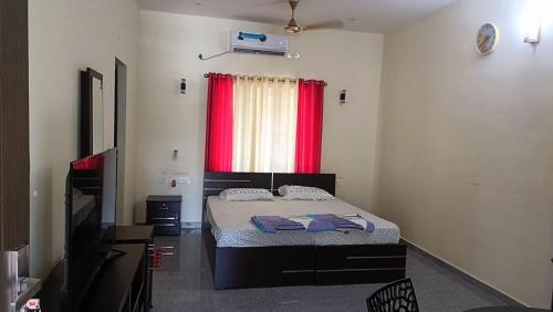 a bedroom with a bed and a red window at Jewel Homes Thattekad - ISO 9001 certified Birding & Family Nature Stay in Thattakād