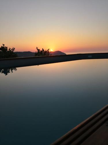 a reflection of the sunset in a body of water at Casa Leonardo a Poggi in Imperia
