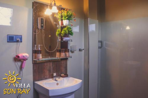 a bathroom with a sink and a shower at Villa Sun Ray in Tissamaharama