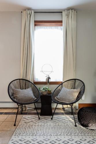 two chairs in a living room with a window at Spacious Stay near Yale in Downtown New Haven in New Haven