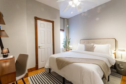 a white bedroom with a bed and a sink at Spacious Stay near Yale in Downtown New Haven in New Haven