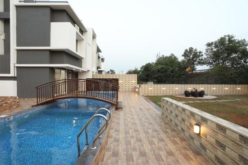 a swimming pool in front of a building at Casa Lola in Lonavala