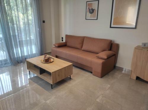 a living room with a couch and a coffee table at Pearl Apartel in Volos