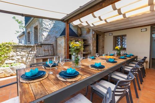 a long wooden table and chairs in a room at 21 Sleeps Private Pool Villa & BBQ Near Barcelona in Rocafort
