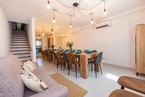a dining room with a long table and chairs at 21 Sleeps Private Pool Villa & BBQ Near Barcelona in Rocafort