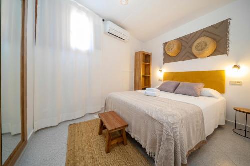 a bedroom with a white bed and a table at 21 Sleeps Private Pool Villa & BBQ Near Barcelona in Rocafort