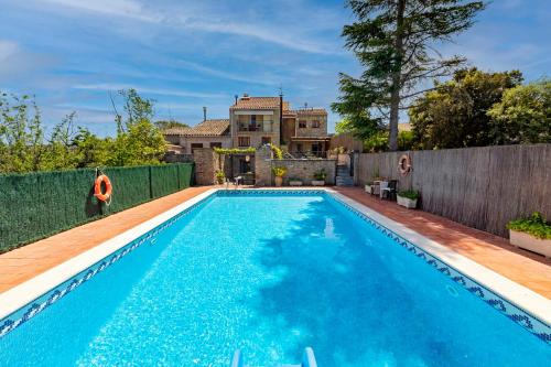 a swimming pool in the backyard of a house at 21 Sleeps Private Pool Villa & BBQ Near Barcelona in Rocafort