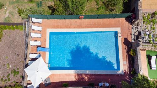 an overhead view of a swimming pool in a building at 21 Sleeps Private Pool Villa & BBQ Near Barcelona in Rocafort