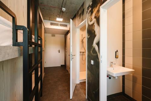 a bathroom with a sink and a toilet in a room at Easy One Premium Art Hostel in Kraków