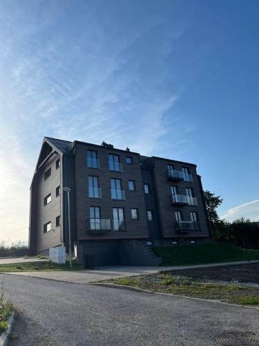a large black building on the side of a road at Horský Apartmán Černý Důl in Lauterwasser