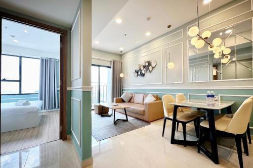 a living room with a couch and a dining room at Yu Stay Apartment in Soho D1 near Bui Vien walking street in Ho Chi Minh City