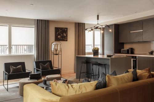 a living room with a couch and a kitchen at 9 Kings, Hudson Quarters- FREE PARKING in York