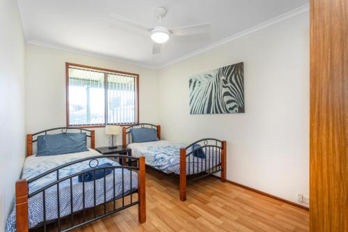 a bedroom with two bunk beds and a window at Cables Beach House Lancelin in Lancelin