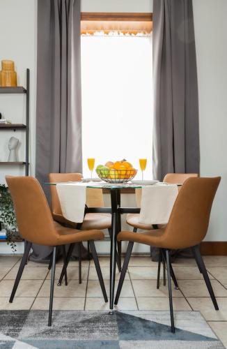 a dining room table with chairs and a bowl of fruit on it at Spacious Stay near Yale in Downtown New Haven in New Haven