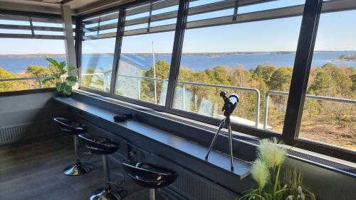 a room with a camera on a tripod in front of a window at Vanha-Merivartioasema in Kotka