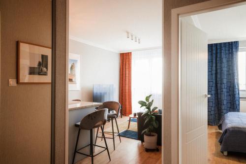 a room with a kitchen and a bedroom with a bed at Apartamenty Blue in Biała Podlaska